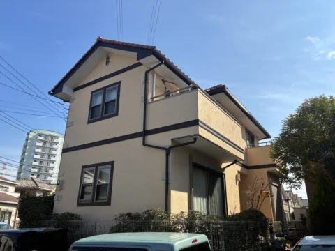 外壁塗装が完了し、艶を抑えたマットな質感が美しい、落ち着きのある外観に仕上がりました。今回使用した日本ペイントの「パーフェクトトゥルーマット」により、光沢を抑えた上品な仕上がりを実現。ベージュ系の外壁とダークブラウンの帯板や付帯部が調和し、建物本来のデザインを活かした統一感のある外観となりました。

T様は色選びに強いこだわりをお持ちで、施工前にはカラーシミュレーションを何度も行い、近隣のお住まいの外壁色も参考にしながら、理想の仕上がりを追求されました。その思いにお応えできるよう、色味だけでなく、艶消しならではの質感にも配慮しながら丁寧に施工しました。

外壁全体を美しく塗り替えることで、落ち着きと高級感を感じさせる仕上がりとなりました。見た目の美しさはもちろん、塗装によって外壁を保護し、これからも大切なお住まいを長く維持していただけるよう施工しました。